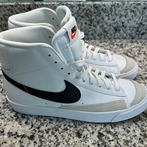 Nike Blazers White and Black High-Tops with Orange Nike Swoosh Detail